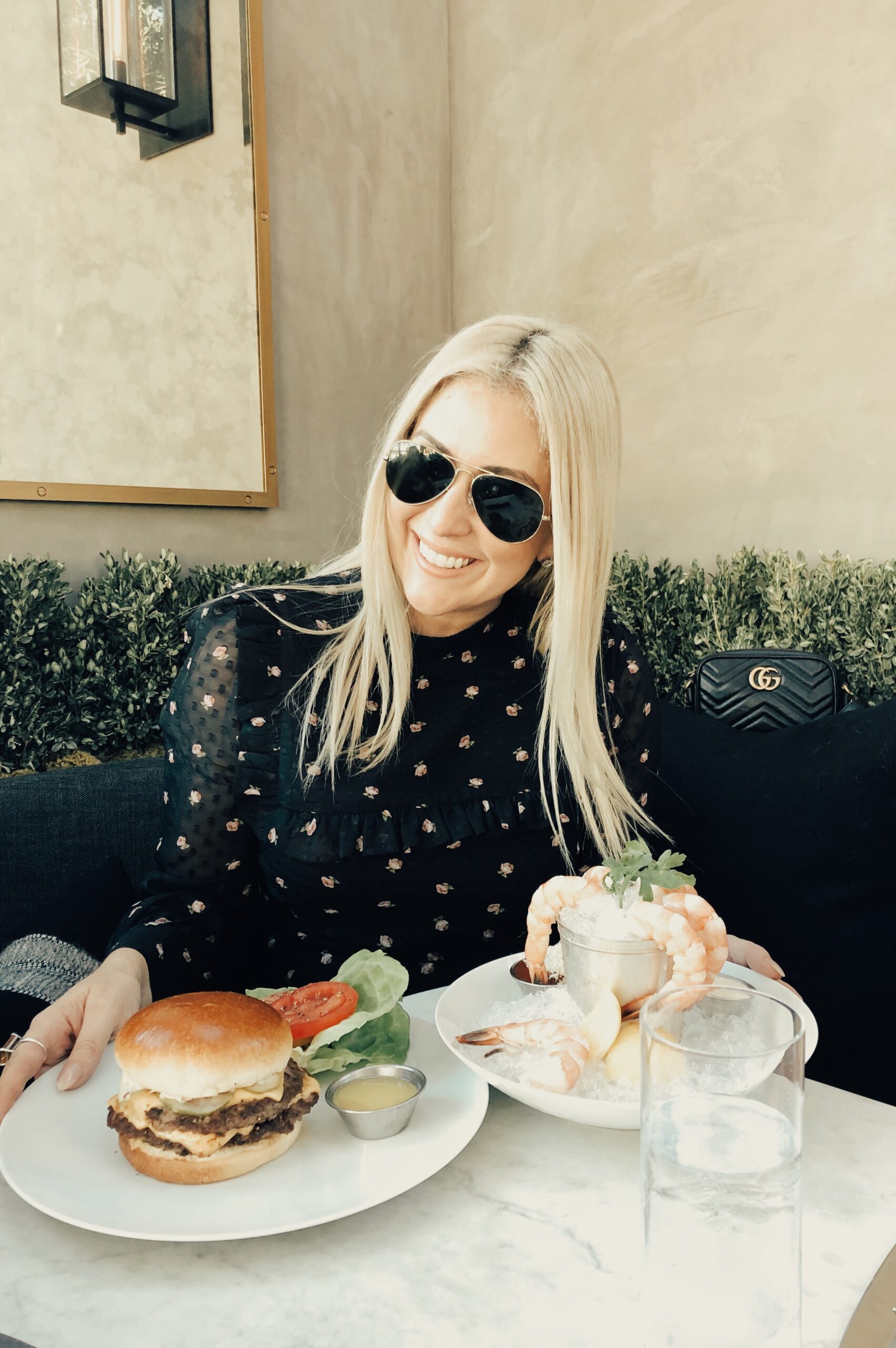 Fashion and food blogger Kat Ensign at RH Yountville with a burger