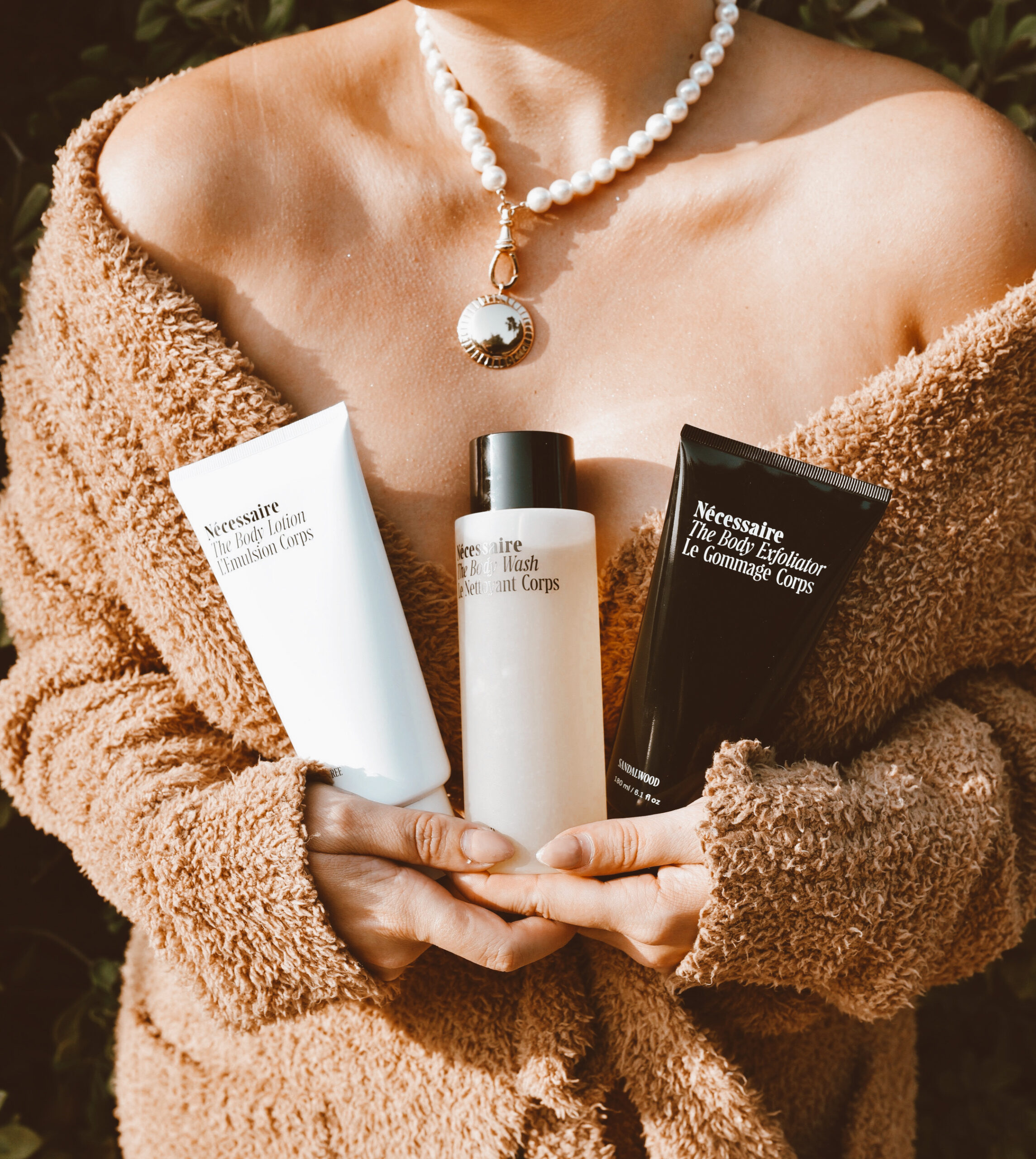 San Francisco fashion and lifestyle blogger KatWalkSF hold the Nécessaire The Body Essentials Kit in her SKIMS robe