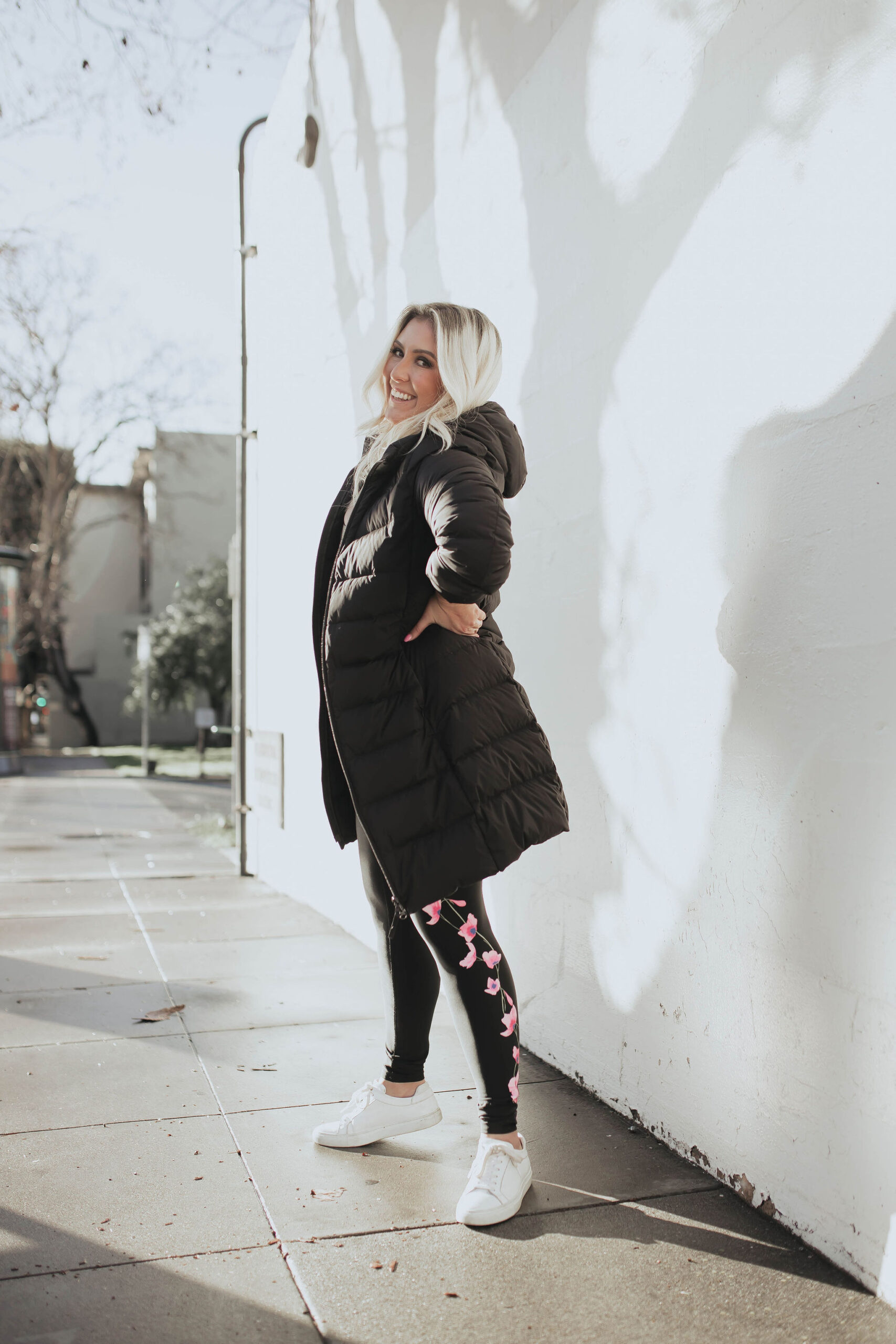 San Francisco blogger Kat Ensign wears the Spanx Illuminate-Her Collection with a Uniqlo Puffer and M. Gemi sneakers.
