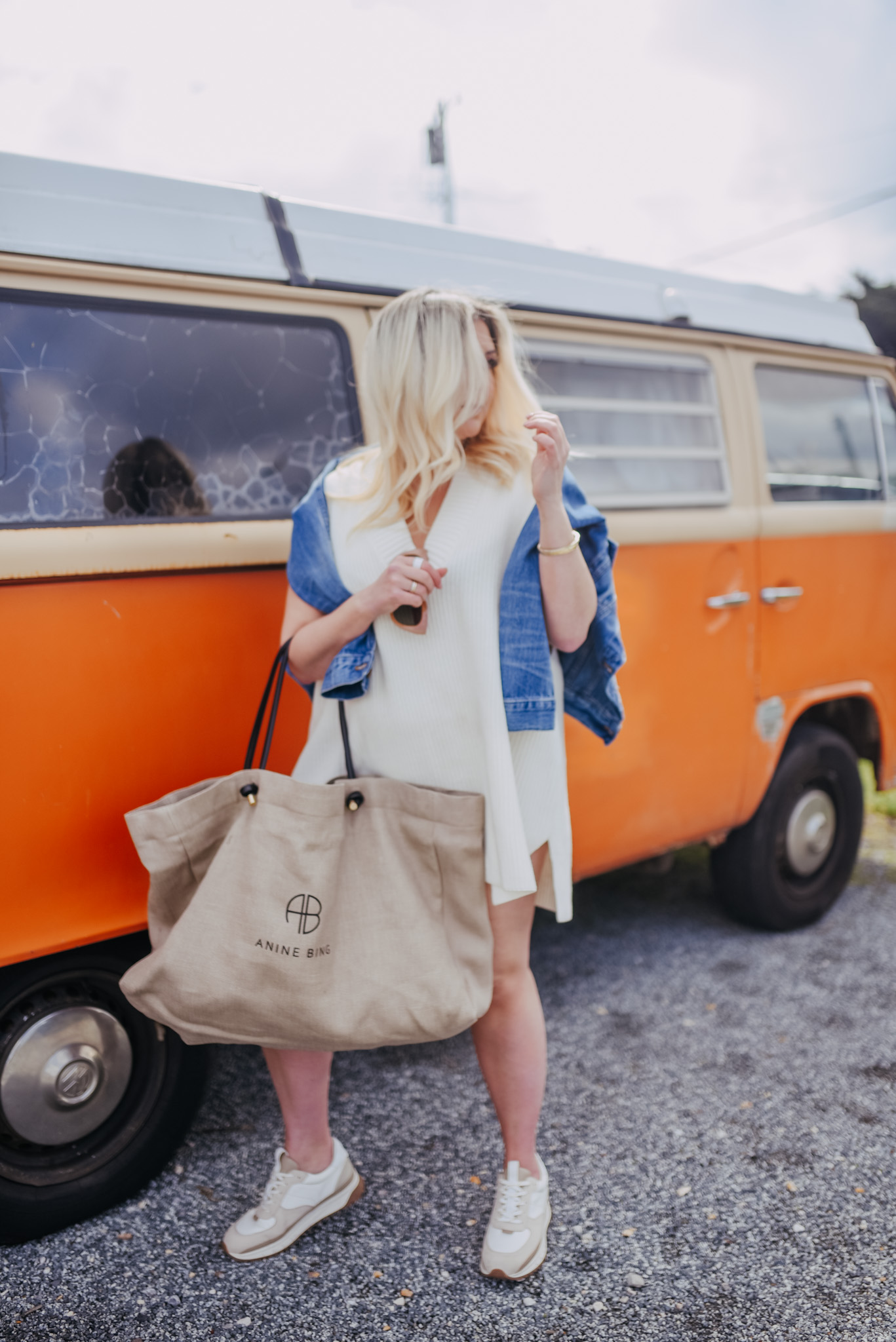 Fashion blogger KatWalkSF standing in front of a vintage VW van holding an Anine Bing Bag