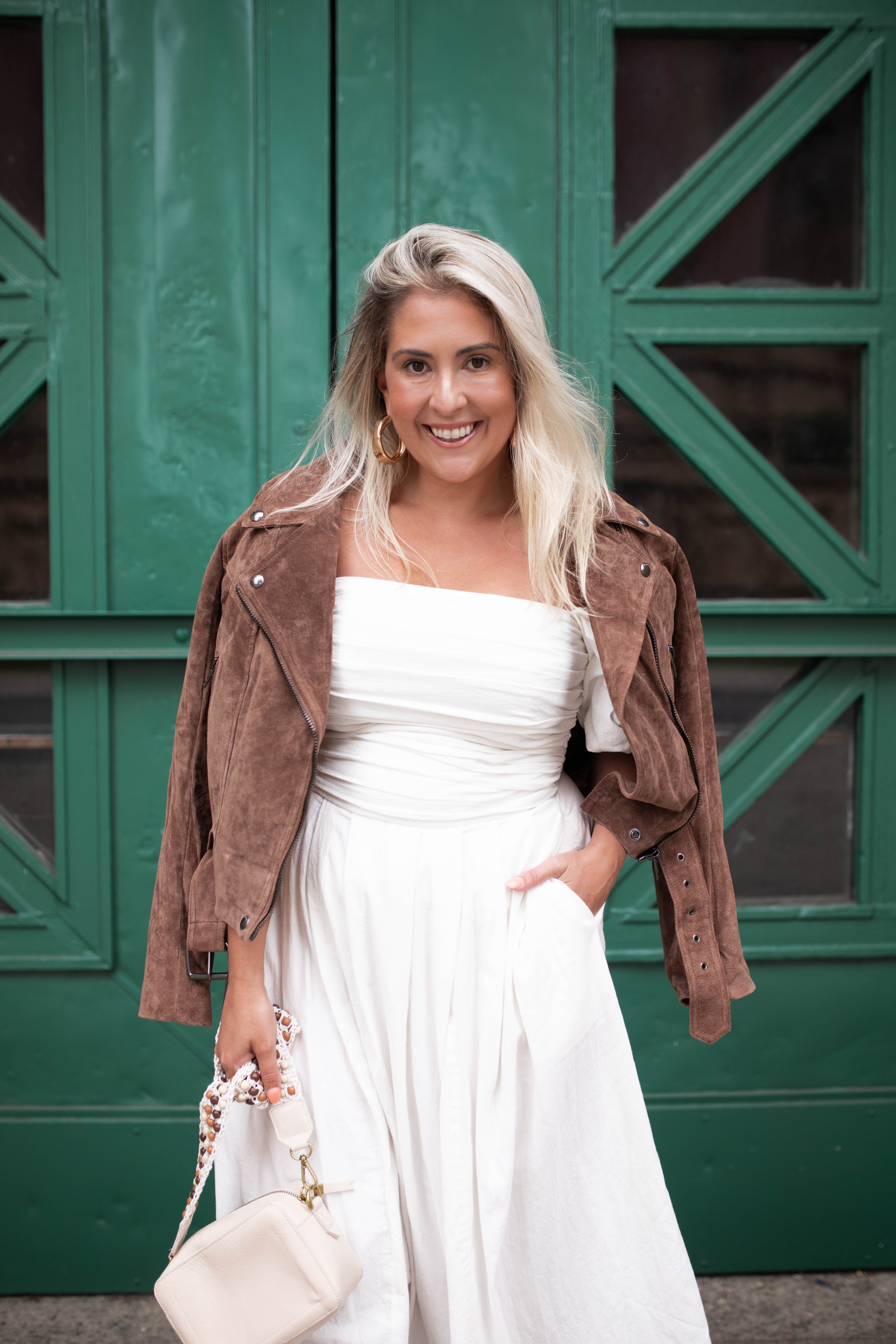 San Francisco blogger Katwalksf styles the Free People Ain't She a Beaut Puff Sleeve Ruched Dress with a brown suede jacket.