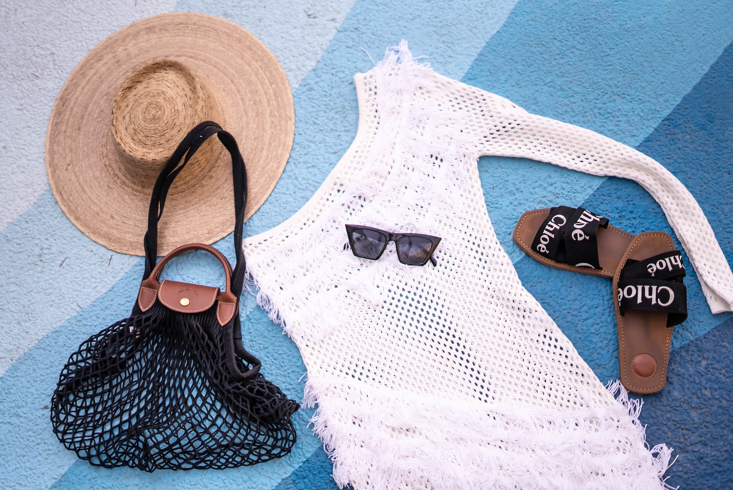 The Revolve Tularosa Peek A Boo dress and coverup styled with a Lack of Color hat, chloe woody sandals and longchamp bag.