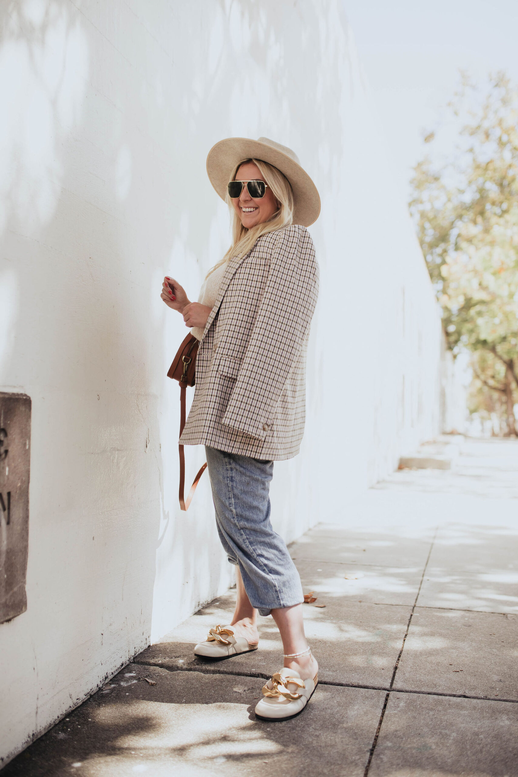 San Francisco fashion blogger KatWalkSF wears a Madewell blazer, sweater vest and leather bag with the Rag & Bone miramar jeans.